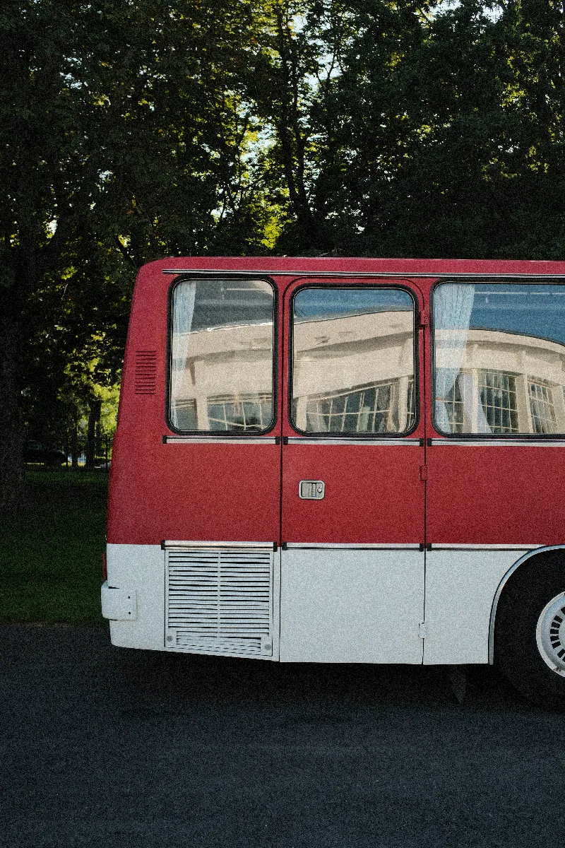 A photo of the back of a retro red bus.