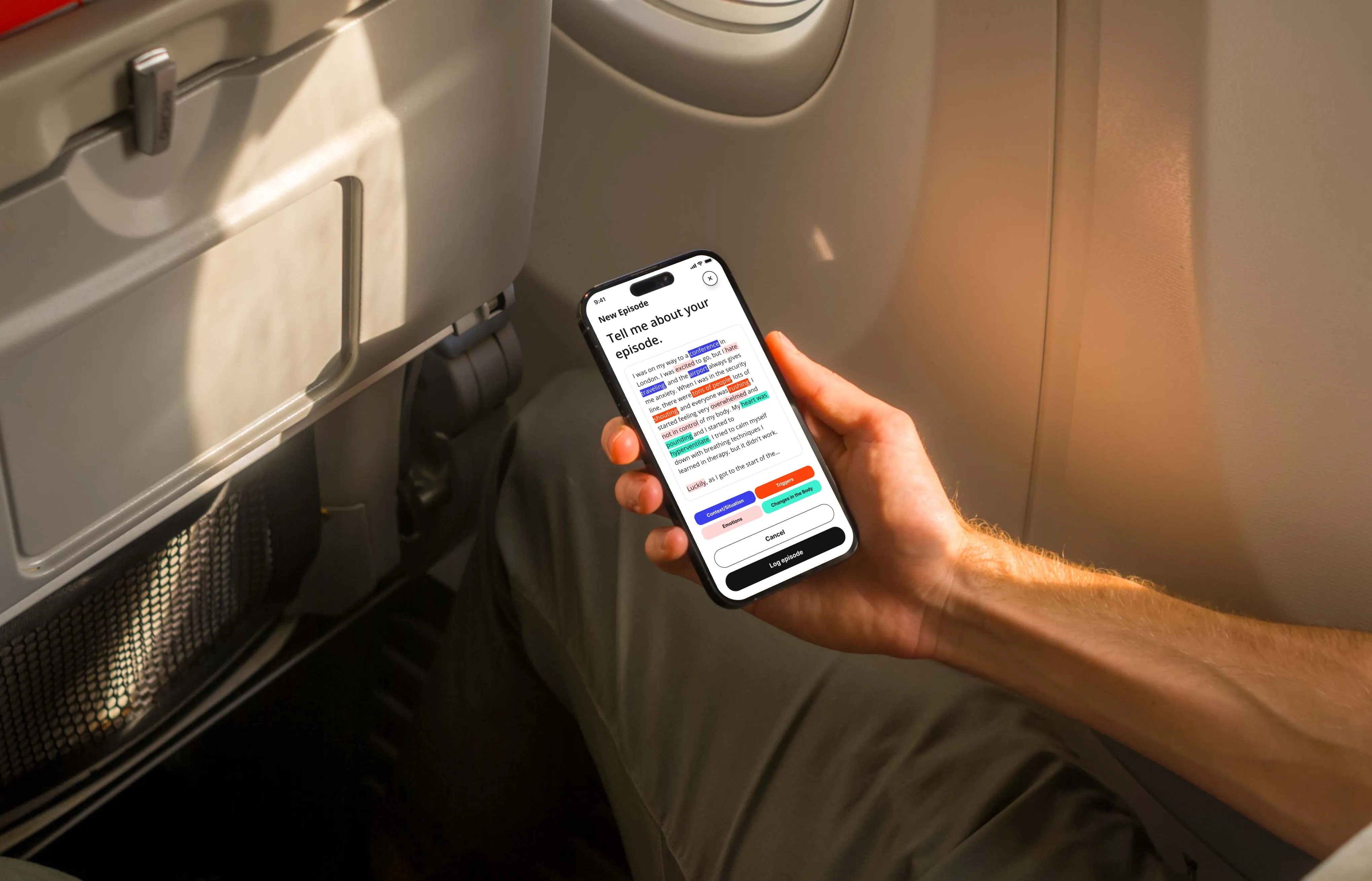 A man holding a phone in an airplane and logging his anxious airport episode.